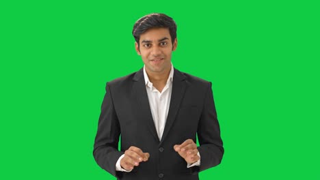 Happy-Indian-businessman-talking-in-meeting-Green-screen
