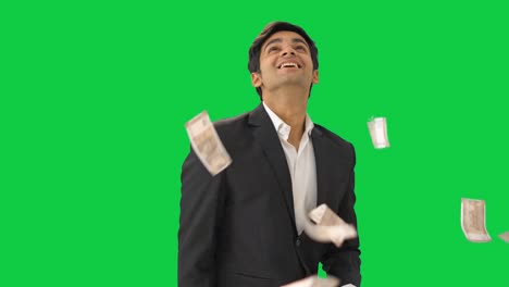 Rich-Indian-businessman-throwing-money-in-air-Green-screen