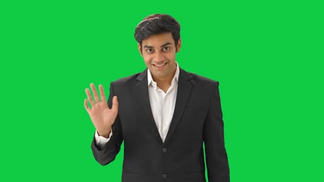 Happy-Indian-businessman-saying-Hi-and-waving-hand-Green-screen