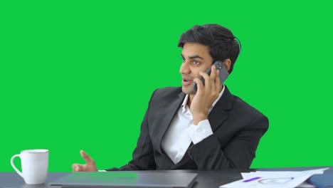 Happy-Indian-businessman-talking-on-phone-Green-screen