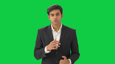 Indian-manager-talking-to-employees-in-meeting-Green-screen