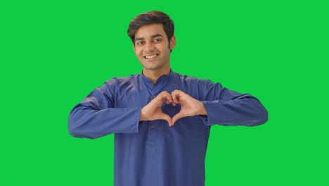 Cute-Indian-boy-showing-heart-sign-Green-screen