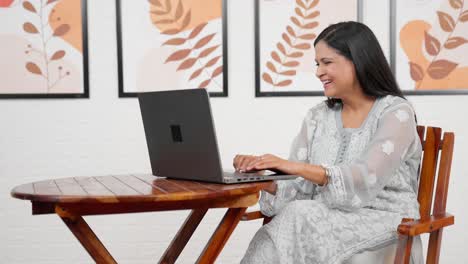 Happy-woman-working-on-laptop