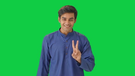 Cute-Indian-boy-showing-victory-sign-Green-screen