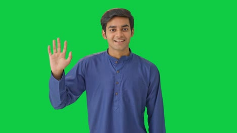 Indian-man-waving-hand-and-saying-hello-Green-screen
