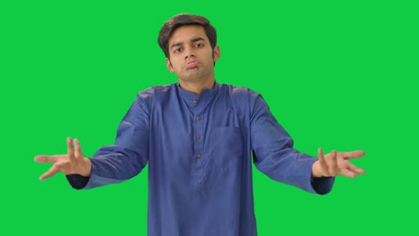 Dumb-Indian-man-symbolizing-I-don't-know-sign-Green-screen
