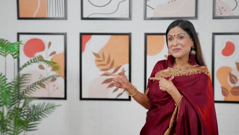 Indian-woman-pointing-left-at-Copy-space