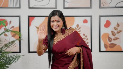 Indian-woman-saying-Hello-and-waving-hand