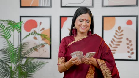 Happy-Indian-woman-counting-money