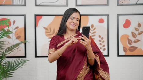 Excited-Indian-woman-scrolling-phone