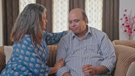 Old-Indian-husband-get-consoled-by-his-wife