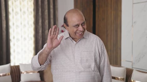 Happy-old-Indian-uncle-waving-Hi-to-the-camera