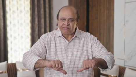 Disappointed-Indian-old-man-showing-thumbs-down