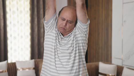 Fat-Indian-old-man-doing-full-body-stretch-and-exercise