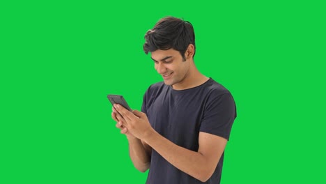 Happy-Indian-boy-chatting-with-someone--Green-screen