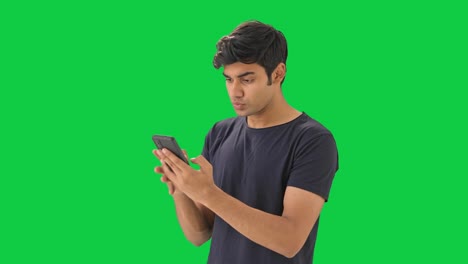 Angry-Indian-boy-chatting-with-someone-Green-screen