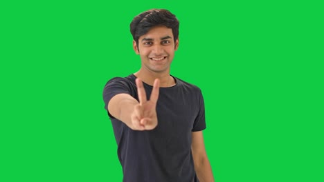 Indian-boy-showing-victory-sign--Green-screen