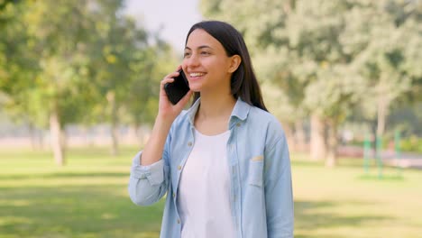 Happy-Indian-girl-talking-on-phone
