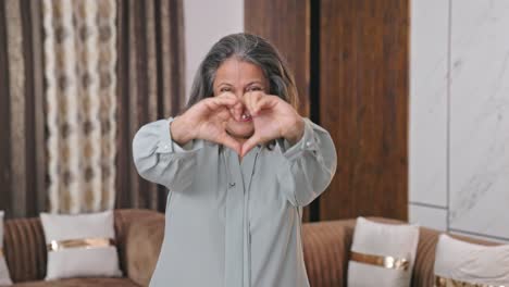 Happy-Indian-woman-making-heart-sign