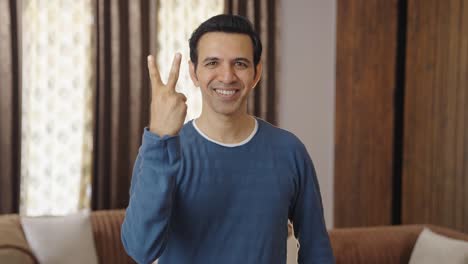 Happy-Indian-gesturing-victory-and-smiling