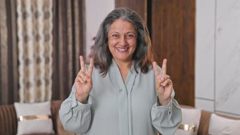 Happy-modern-Indian-woman-showing-victory-sign