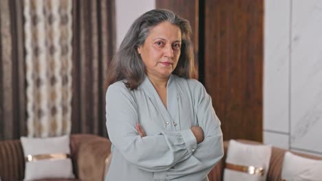Confident-Indian-businesswoman-standing-crossed-hands