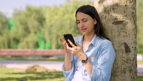 Indian-girl-scrolling-through-phone