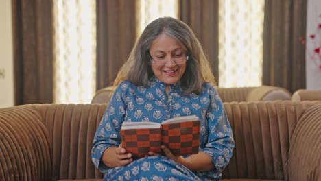 Happy-Indian-aged-woman-reading-a-book