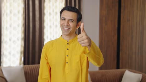 Proud-Indian-father-showing-thumbs-up-in-ethnic-outfit