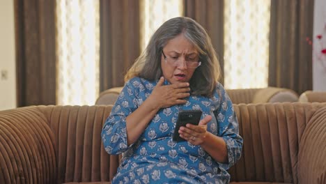 Upset-Indian-old-woman-sees-a-shocking-news-on-mobile-phone