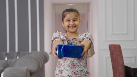 Indian-kid-girl-giving-gifts-to-the-camera