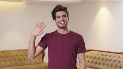 Happy-Indian-man-waving-Hi-to-the-camera