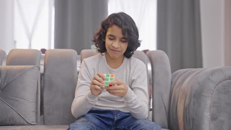 Angry-Indian-kid-boy-gets-frustrated-unable-to-solve-Rubik's-cube