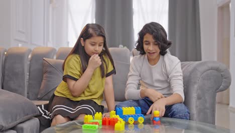 Verwirrte-Indische-Kinder,-Die-Versuchen,-Einen-Legoturm-Zu-Bauen