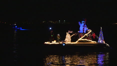 A-holiday-Christmas-parade-of-boats-makes-its-way-through-a-harbor-in-Florida