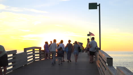 Crowds-walk-on-a-pier-at-sunset-in-Florida