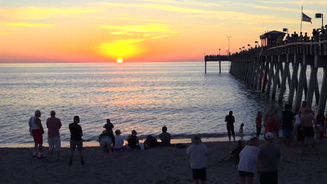 Crowds-gather-around-a-pier-at-sunset-in-Florida