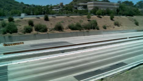 Zoom-out-and-pan-right-to-left-over-an-empty-stretch-of-the-405-freeway-in-Los-Angles-as-crews-tear-down-part-of-a-bridge