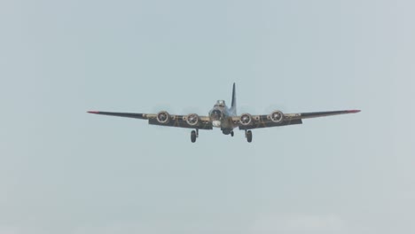 A-vintage-airplane-flies-low-over-an-airfield