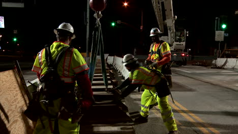 Construction-workers-work-on-a-freeway-overpass-in-time-lapse-at-night-in-Los-Angeles