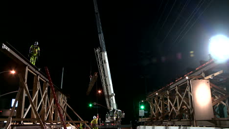 Construction-workers-work-on-a-freeway-overpass-at-night-in-Los-Angeles-3