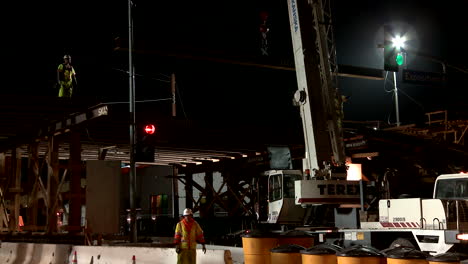 Construction-workers-work-on-a-freeway-overpass-at-night-in-Los-Angeles-4