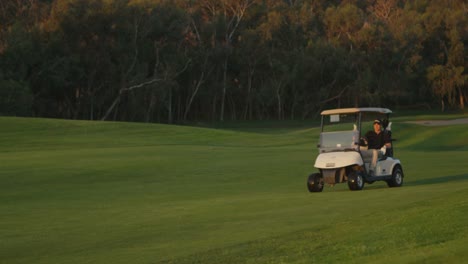 Golfers-ride-in-a-cart-on-a-golf-course
