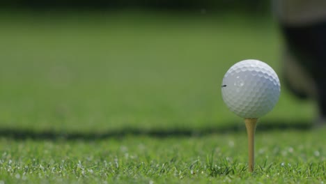 Closeup-of-a-golf-ball-being-hit-off-a-tee