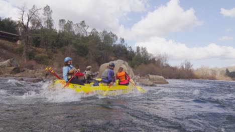 A-group-paddles-in-an-inflatable-raft-on-a-fast-flowing-river