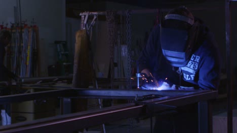 An-arc-welder-welds-in-a-workshop