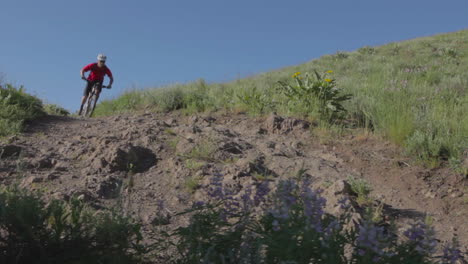 A-mountain-biker-races-through-a-rocky-area