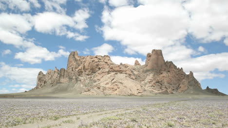 Fluffy-white-clouds-pass-over-New-Mexico\'s-Shiprock