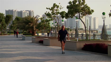 Joggers-run-beside-the-beautiful-skyline-of-Abu-Dhabi-in-the-United-Arab-Emirates