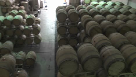 Pan-Across-Barrels-Of-Beer-In-A-Warehouse